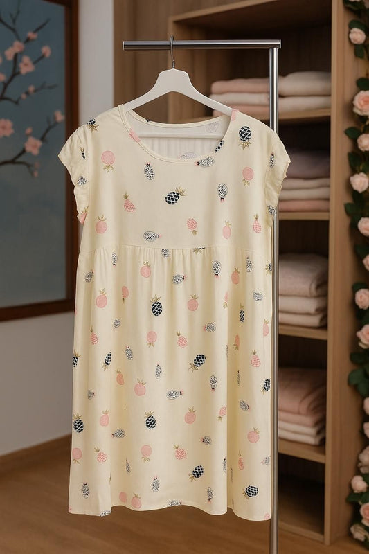 Beige dress with floral pattern on a hanger in a room with shelves and decorative elements.