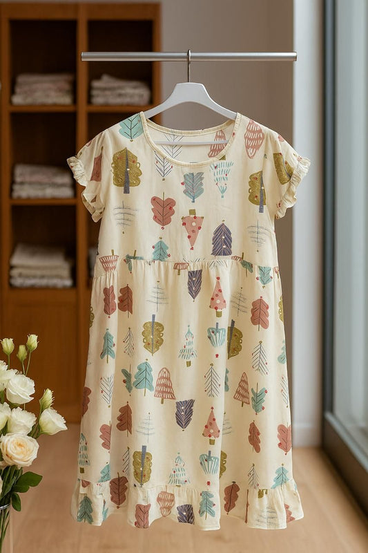 Beige dress with tree pattern on a hanger against a neutral background