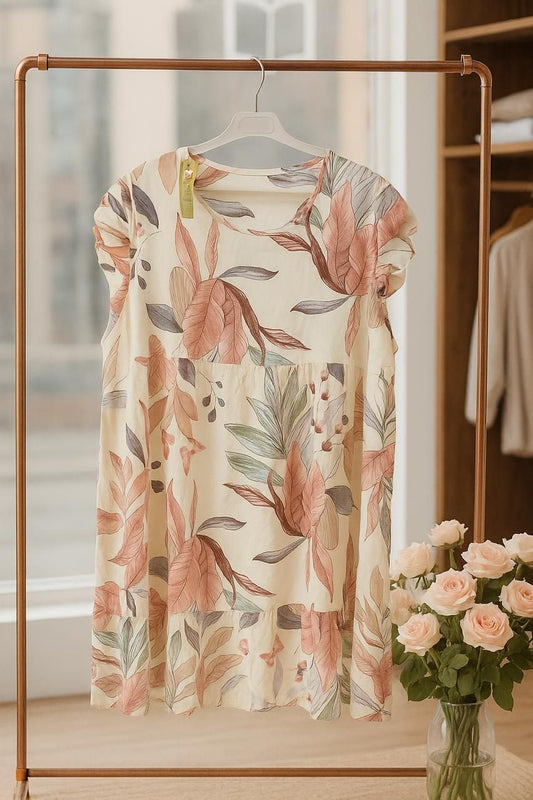 Cream floral dress on a hanger with a blurred background