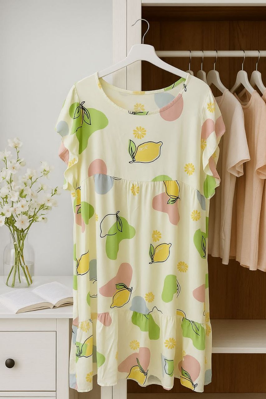 Floral-patterned dress on a hanger with a background of clothes and a vase.
