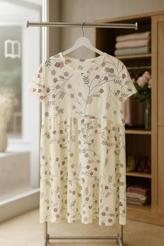 Floral dress hanging on a rack in a room with a bookshelf in the background
