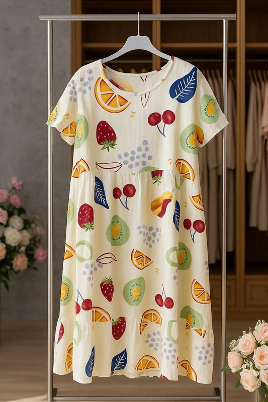 Dress with fruit pattern on a hanger in a store setting